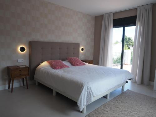 a bedroom with a bed with two pillows and a window at El Cafetal de Veronica in Marbella