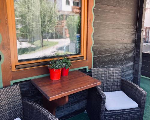 a wooden table and two chairs on a patio at Ferienwohnung Gams in Finkenberg