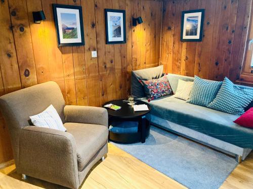 a living room with a couch and a chair at Ferienwohnung Gams in Finkenberg