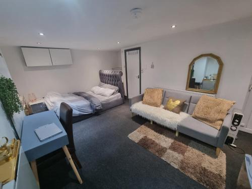 a living room with a couch and a bed at Affordable Private Space in a Central Part of Leeds- Free WIFI, Free Parking in Leeds