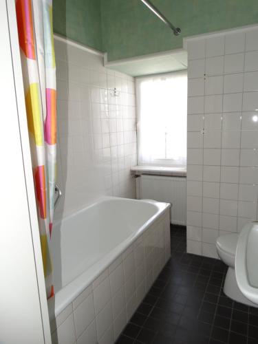 a bathroom with a tub and a toilet at Landhaus Arnoth in Kleinich