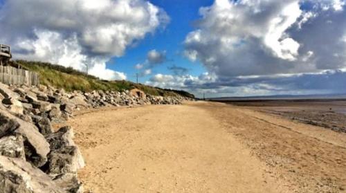 a dirt road next to a rock wall at Victorian Guest House 200m from the Seafront in West Kirby