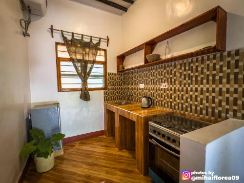 a kitchen with a sink and a stove at Tofauti Inn in Makunduchi