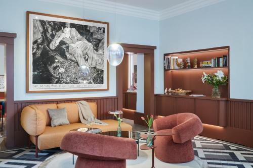 a living room with a couch and two chairs at Engelwirt Hotel & Apartments in Berching