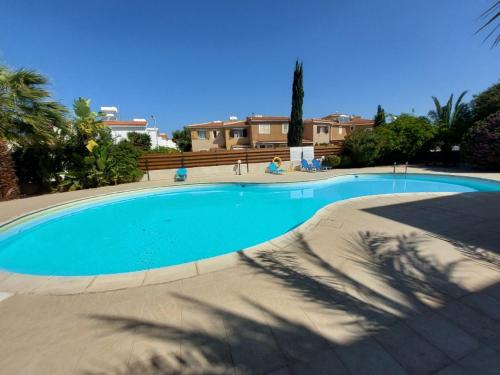 a large blue swimming pool in a resort at MyCyprusStay - Jo's Cosy 1 Bedroom Apartment in Paphos City