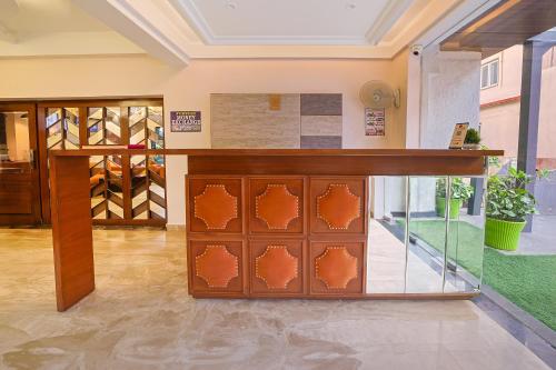 a room with a counter with a glass door at Green Hotel - Behind Parmarth Niketan in Rishīkesh