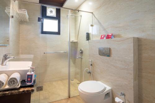 a bathroom with a shower and a toilet and a sink at Spree Hotel Agra - Walking Distance to Tajmahal in Agra