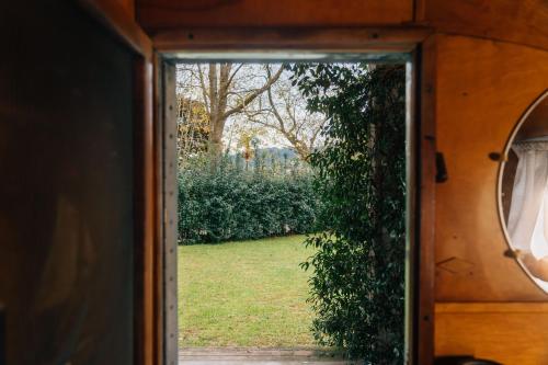 an open door with a view of a yard at The Caravan in Hoz de Anero