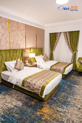 a hotel room with two beds in a room at Odst Jeddah in Jeddah