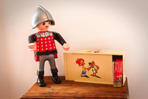 a toy soldier is standing next to a small box at Gîte Le Féodal 3 Etoiles in Tiffauges