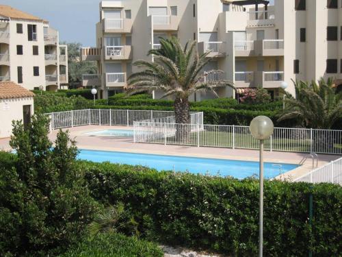 une piscine en face d'un complexe d'appartements dans l'établissement Saint-Cyprien: T2 cabine rénové 6 pers, piscine, parking, à 100m de la plage - FR-1-106-80, à Saint-Cyprien