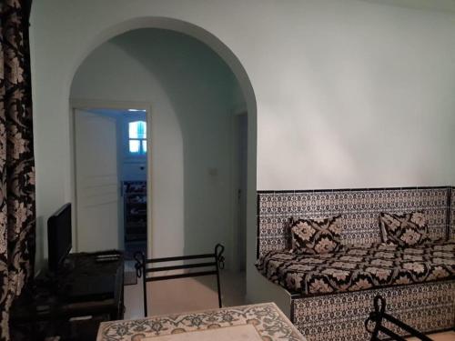a living room with a bed and a couch at Villa Chaâbane in Djerba