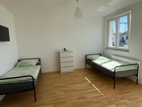 a bedroom with two beds and a window at WPS Residenz in Frankfurt/Main