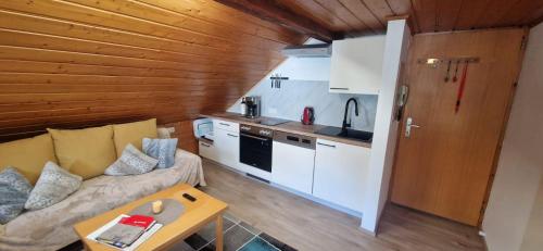 a living room with a couch and a kitchen at Weisshaus Schruns in Schruns-Tschagguns