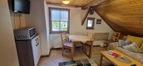 a living room with a couch and a table at Weisshaus Schruns in Schruns-Tschagguns