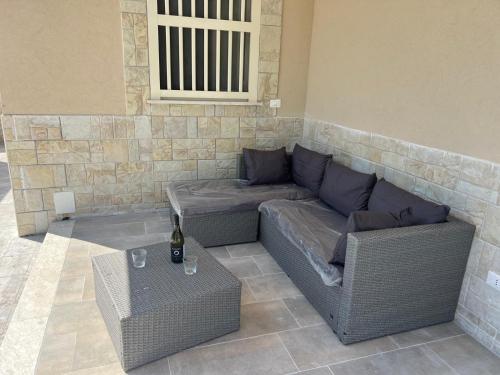 a living room with a couch and a table at Villa Tellina Mare Luna in Granelli