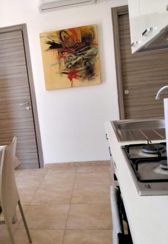 a kitchen with a stove and a counter top at Villa Tellina Mare Luna in Granelli