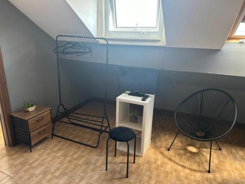 a room with two chairs and a shelf and a window at Manchester Stay Hotel - Free Parking in Manchester