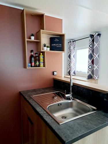 a kitchen counter with a sink and a window at Au 7cent14 in Marcilly-sur-Eure