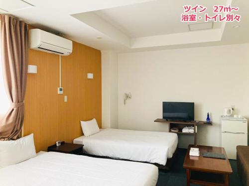 a hotel room with two beds and a tv at Hotel Precia Naha Tsujimachi - Vacation STAY 17058v in Naha