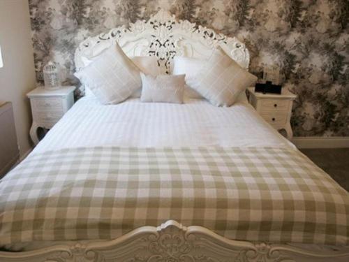 a bedroom with a bed with a checkered blanket at The Lambton Worm in Chester-le-Street