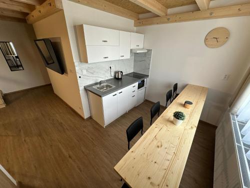 a kitchen and dining room with a wooden table and chairs at Penzion Raketa Bowling in Opava