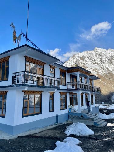 a house in the snow in front of a mountain at The Shangbar in Jispa