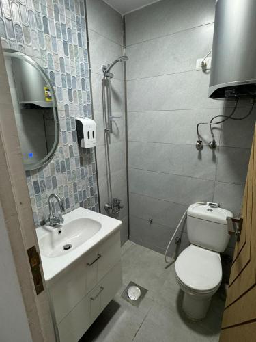 a bathroom with a white toilet and a sink at Downtown Inn in Cairo