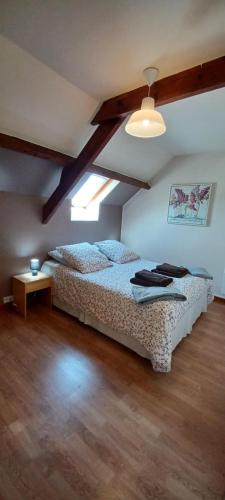 a bedroom with two beds and a window at Gites at La Maison Sans Souci in Le Guislain