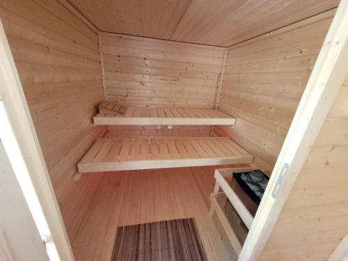 a small wooden sauna with wooden floors and ceilings at Gartenhaus Nossen in Nossen