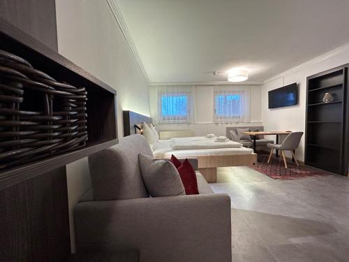 a living room with two beds and a couch at Harmls Aparthotel in Flachau