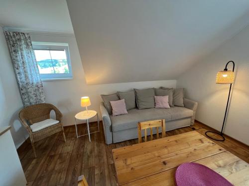a living room with a couch and a table at Apartment Brusinka in Kašperské Hory