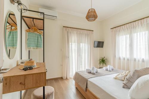 una camera da letto con un letto, una scrivania e uno specchio di MARY DUKE apartment a Nikiti