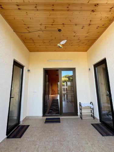 a porch of a house with a wooden ceiling at Hotel Okatsia სასტუმრო ოკაცია in Gordi