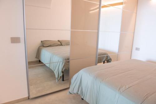una camera da letto con specchio accanto a un letto di Appartamento - Mondovì a Mondovì