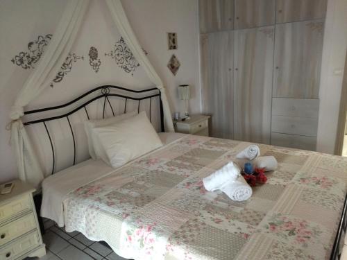 a bedroom with a bed with two stuffed animals on it at Blue Dreams in Almiropotamos