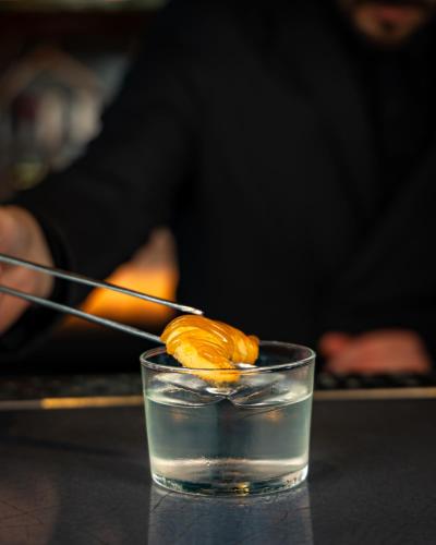 a glass of water with a piece of food on a stick at DoubleTree by Hilton Hotel London - Tower of London in London