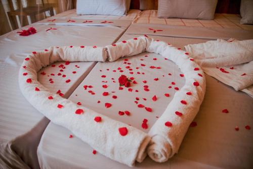 a heart shaped cake on top of a bed at Sinharaja Riverside in Deniyaya