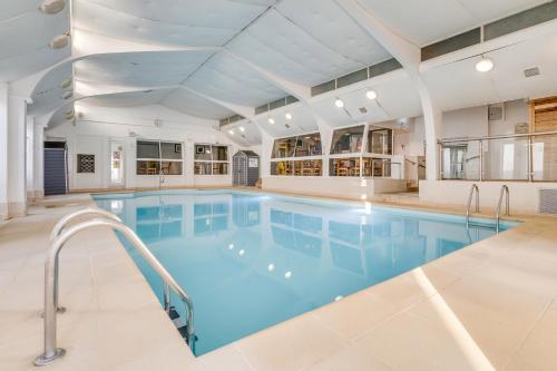 a large indoor swimming pool with blue water at St Ives Hotel in Lytham St Annes