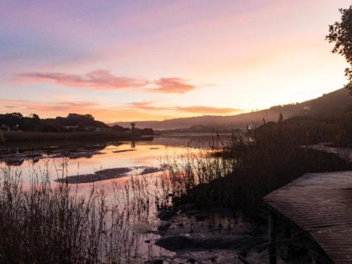 a view of a river at sunset at Cloverleigh Guest House in Wilderness