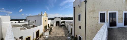 an aerial view of a building with a church at Masseria Borgo San Marco in Fasano