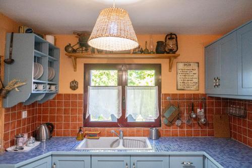 a kitchen with a sink and a window at ΑΝeΜΙ in Anemótia