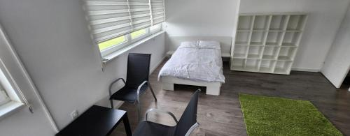 a small room with a bed and a window at Urban villa in Sarajevo