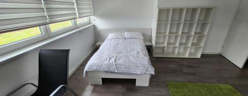 a small bedroom with a bed and a window at Urban villa in Sarajevo