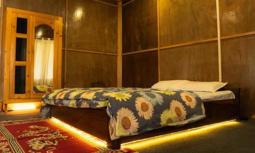 a bedroom with a bed with a flower patterned blanket at Tsejor Homestay in Dirang Dzong