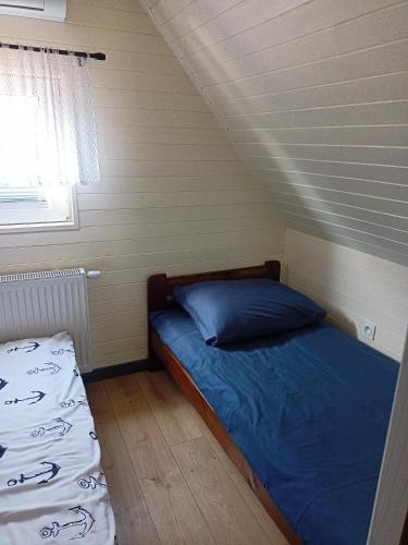Postel nebo postele na pokoji v ubytování Amelia Domek letniskowy