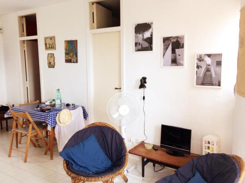 a living room with a table and chairs at La casa di Vittorio de Feo in Procida
