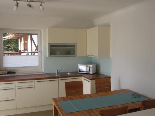 a kitchen with a sink and a microwave at Ferienwohnung Bergpanorama in Fulpmes