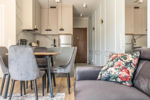 a living room with a couch and a table at Nautica Resort in Giżycko