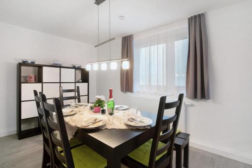 a dining room with a table and chairs and a window at Ferienhaus Doris in Bad Urach